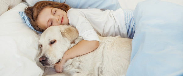 Girl sleeping with pet dog