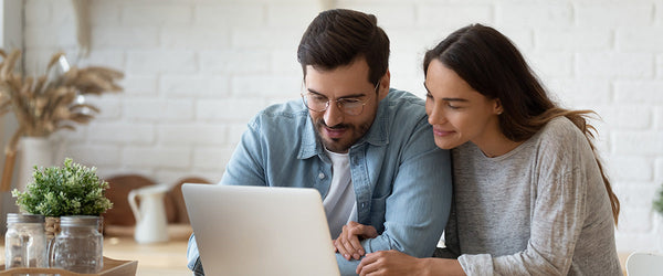 Couple shopping online for a mattress together