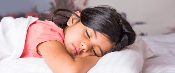 Young girl falling asleep on kids' mattress